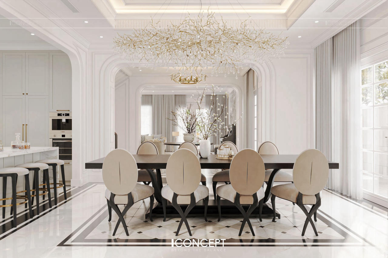 Điểm nhấn tại phòng ăn chính là bộ bàn ăn lớn 6–8 ghế được thiết kế riêng theo phong cách Neo Classic: chân bàn bo cong mềm mại, mặt đá trắng phối vân vàng tự nhiên, ghế bọc da cao cấp với gam màu trung tính nhã nhặn
